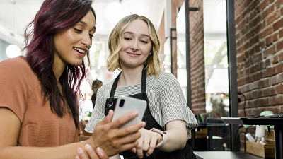 Employee showing customer how to leave a review on Google